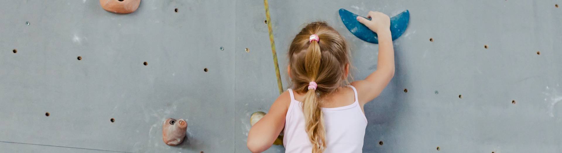 Young girl on a climbing wall